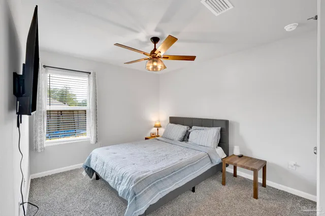 a bedroom with a bed and a window