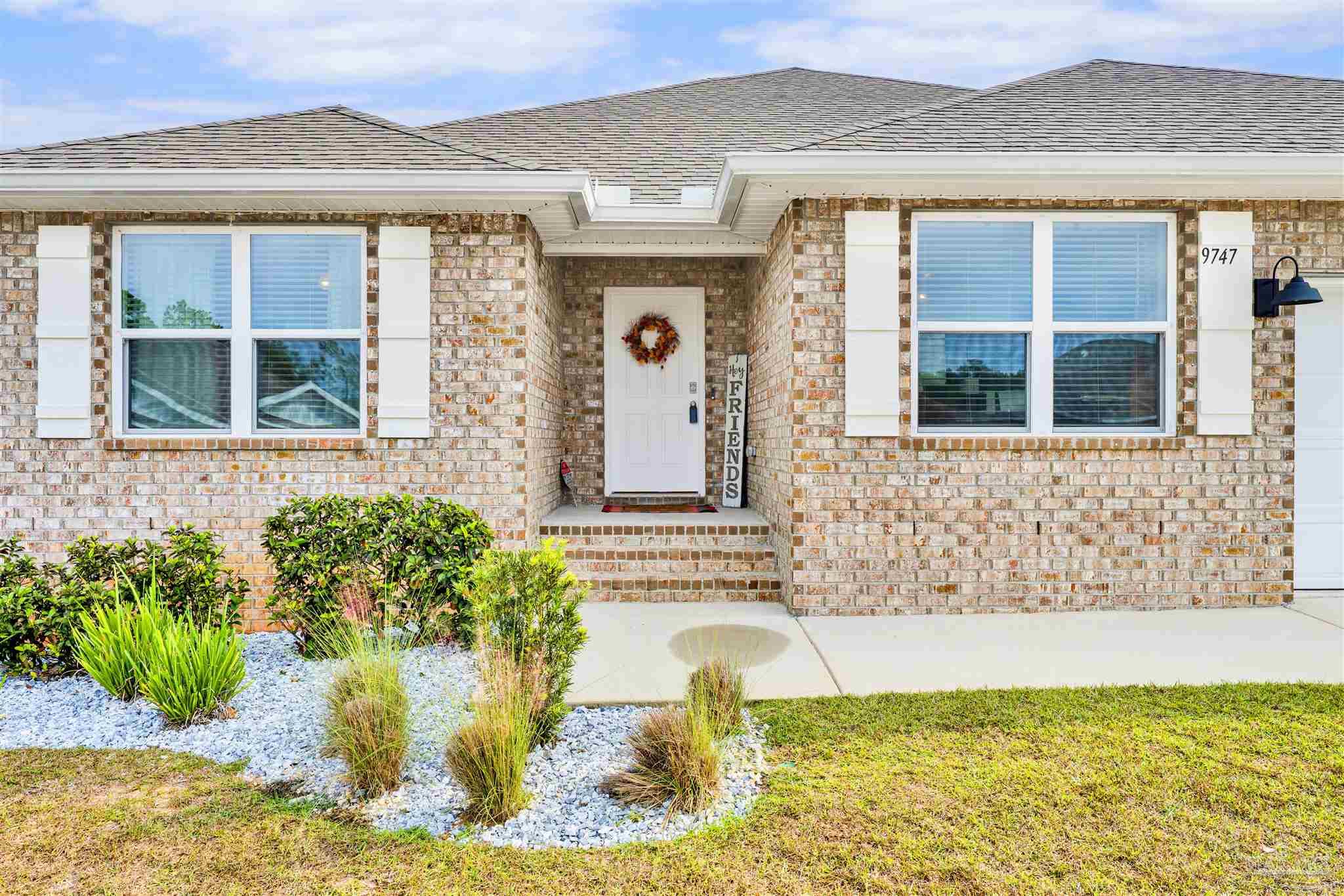 9747 MilleeLoop Loop Pensacola, FL 32526 - Photo 2 of 31 a front view of a house with a yard