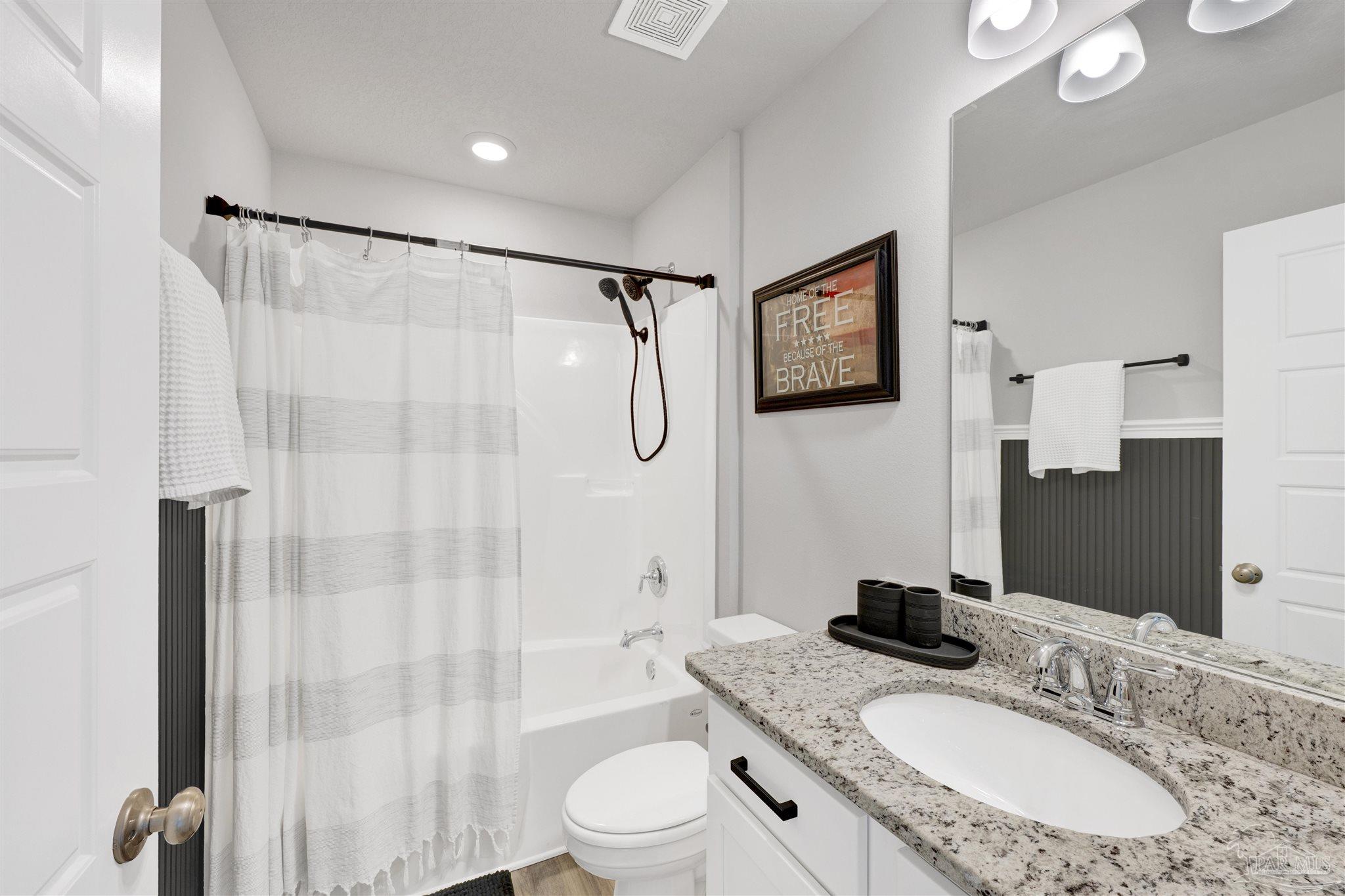 9747 MilleeLoop Loop Pensacola, FL 32526 - Photo 22 of 31 a bathroom with a granite countertop sink toilet a mirror a glass door shower and a mirror