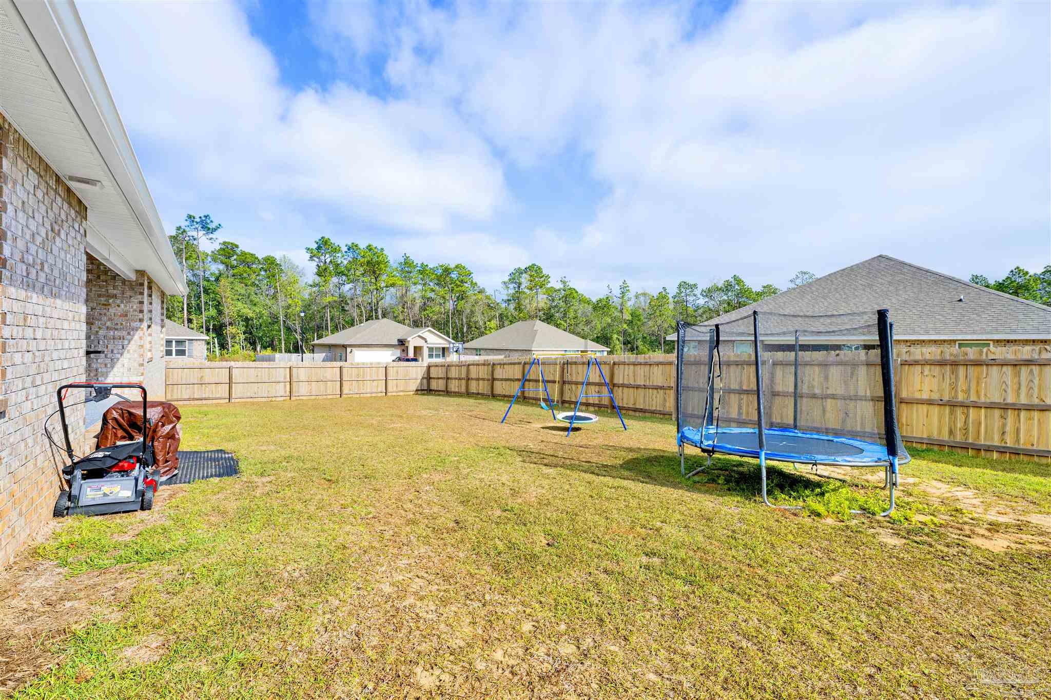 9747 MilleeLoop Loop Pensacola, FL 32526 - Photo 27 of 31 a view of a swimming pool with an outdoor seating