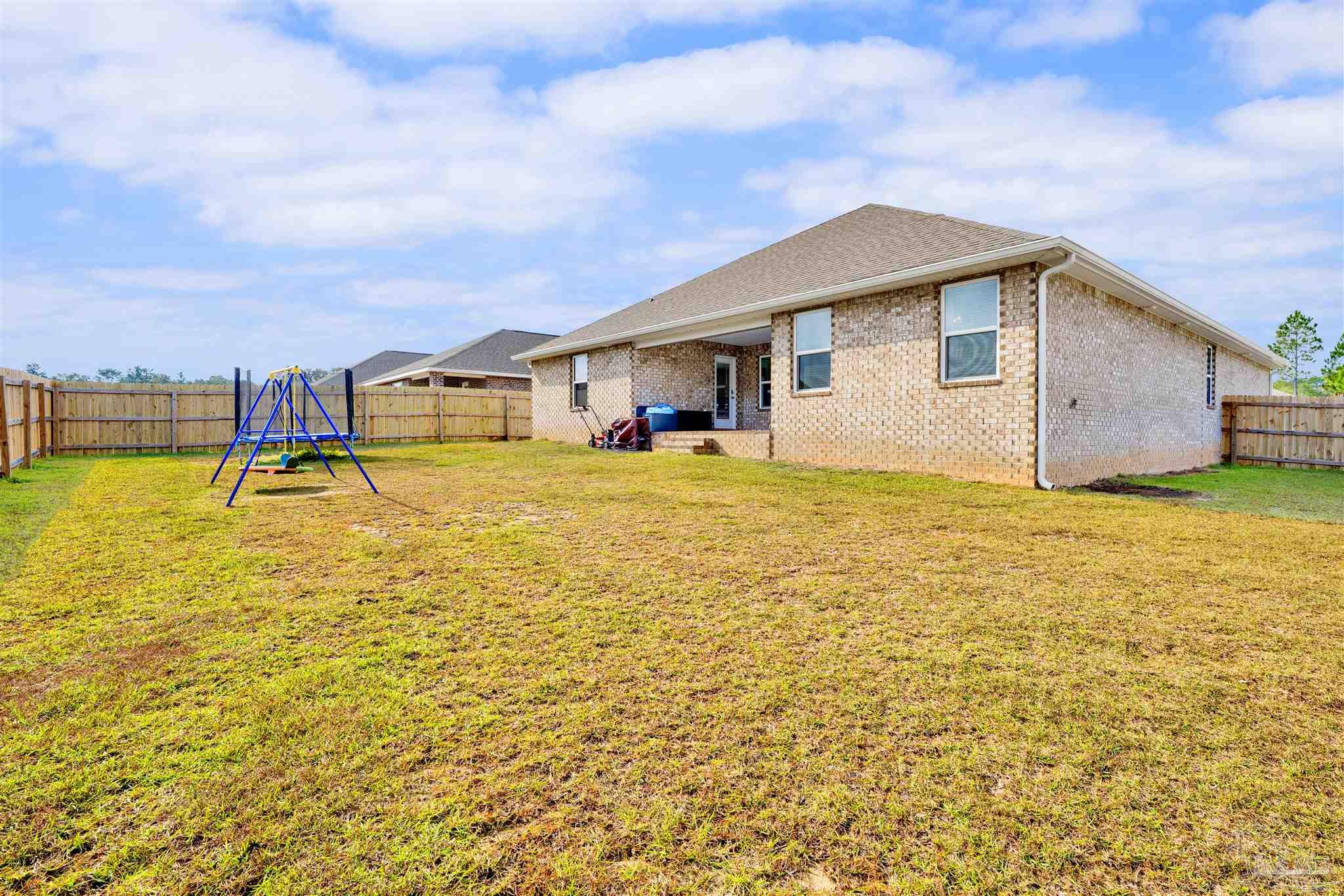 9747 MilleeLoop Loop Pensacola, FL 32526 - Photo 28 of 31 a view of a swimming pool with an outdoor seating