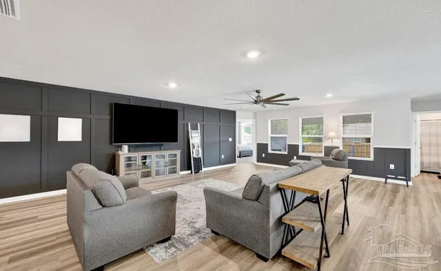 a living room with furniture and a flat screen tv