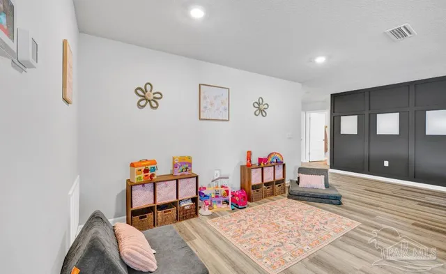 a bedroom with furniture and a wooden floor