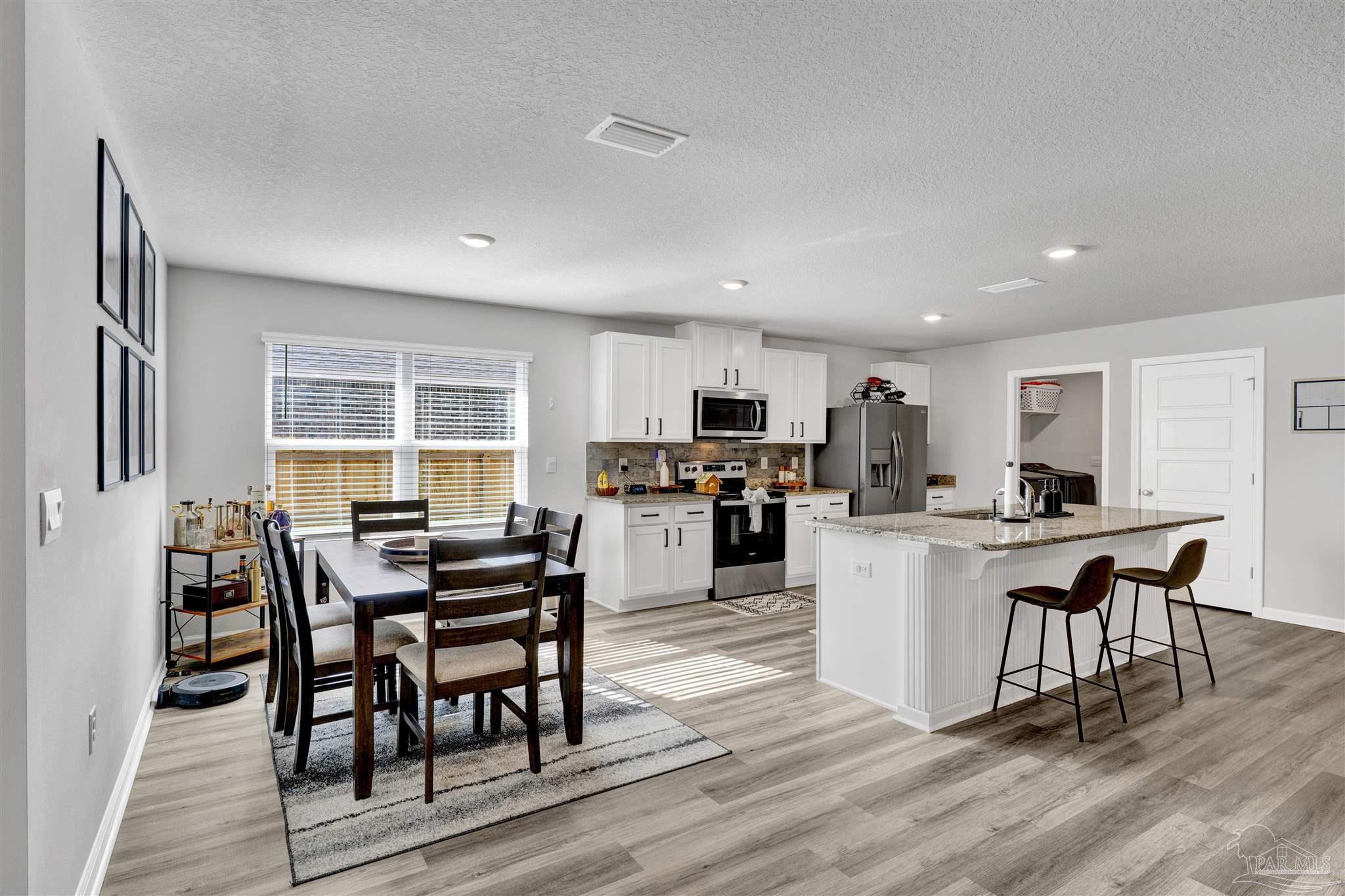 9747 MilleeLoop Loop Pensacola, FL 32526 - Photo 8 of 31 a kitchen with sink a table and chairs