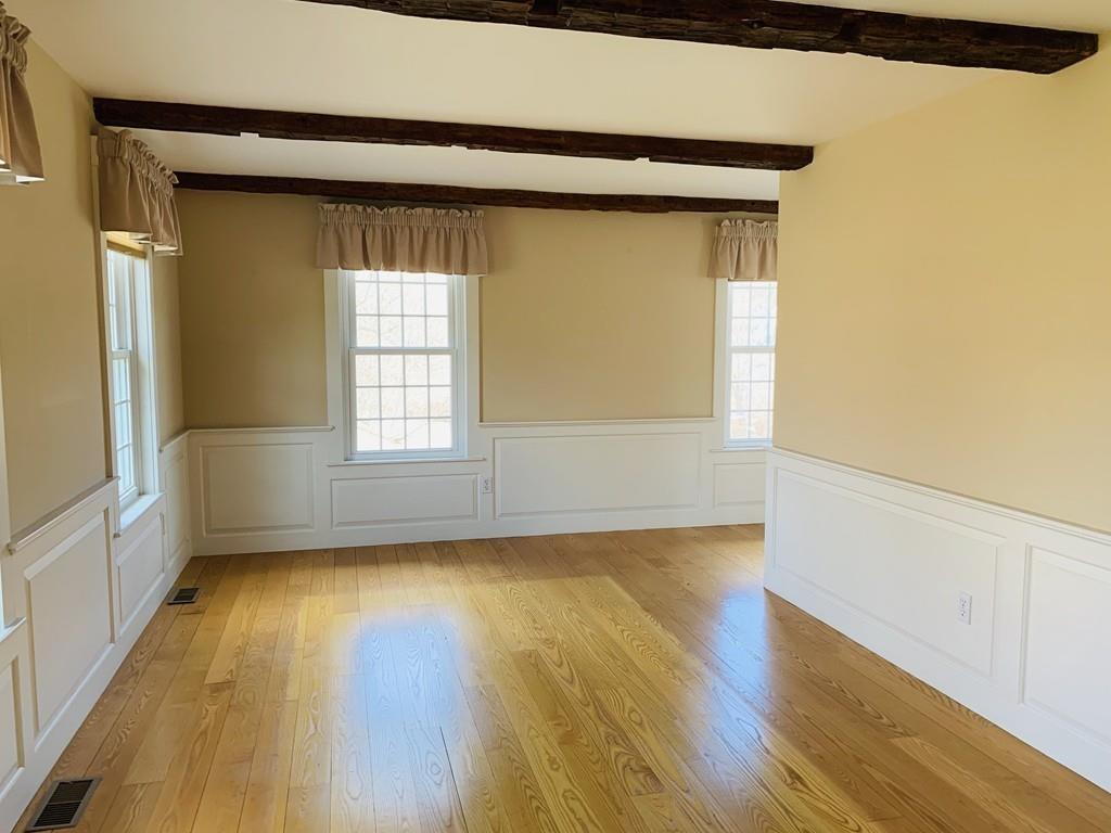 272 Lowell Road Groton, MA 01450 - Photo 5 of 21 a view of a room that has wooden floor in it
