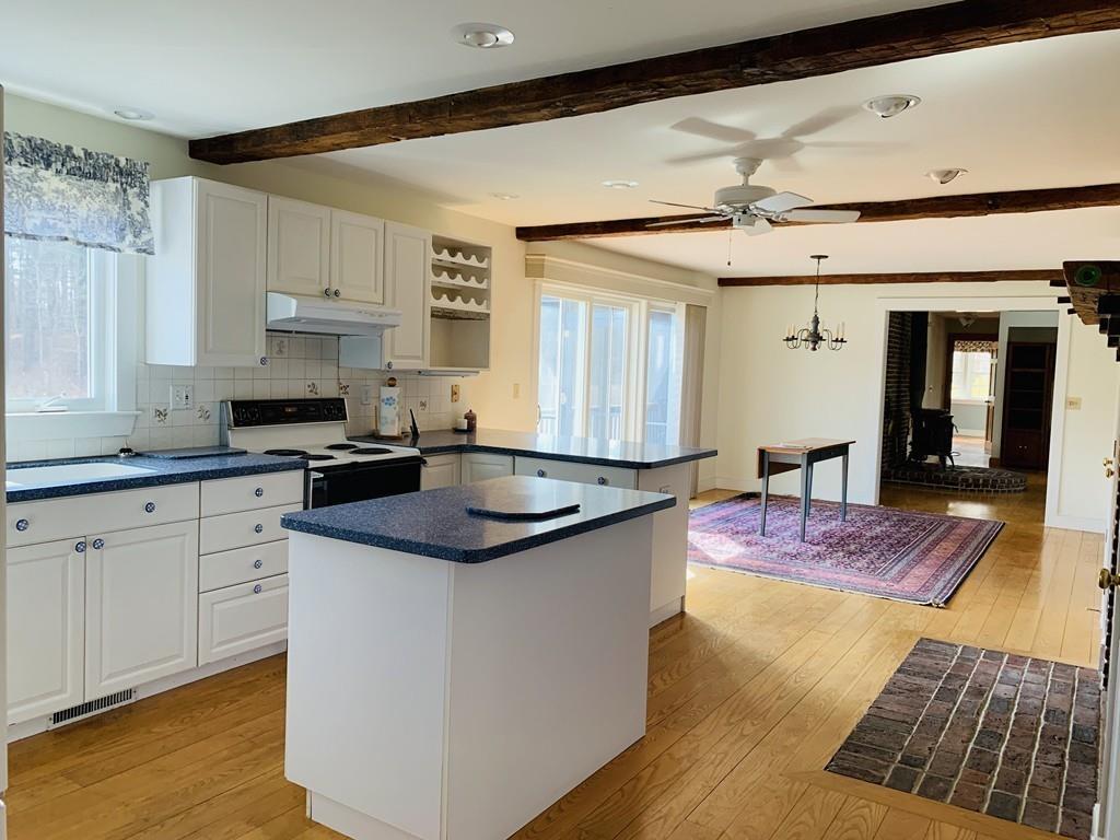 272 Lowell Road Groton, MA 01450 - Photo 6 of 21 a kitchen with stainless steel appliances granite countertop a sink and cabinets