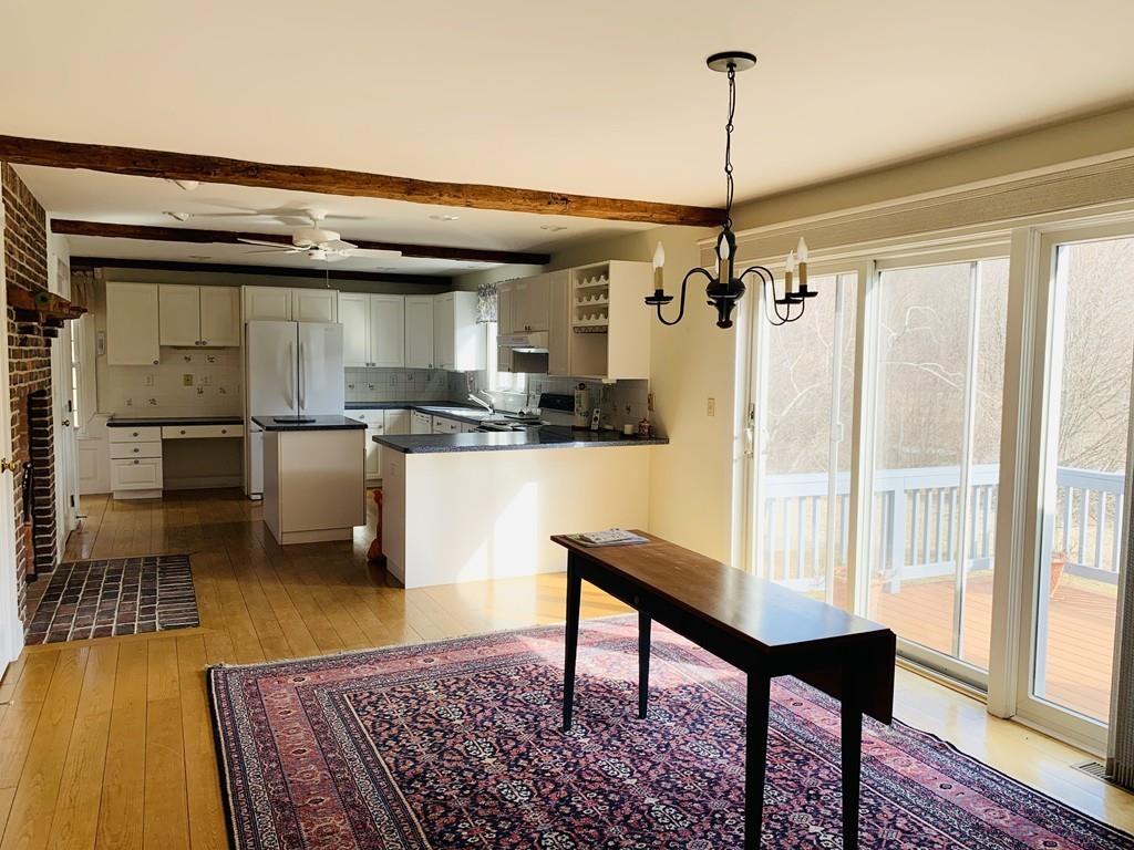 272 Lowell Road Groton, MA 01450 - Photo 7 of 21 a kitchen with stainless steel appliances granite countertop a stove a sink and a refrigerator