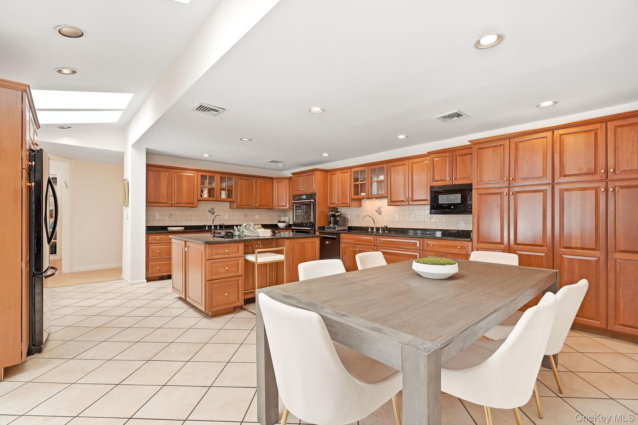 39 Lambert Lane New Rochelle, NY 10804 - Photo 9 of 30 Custom Kitchen with Island, Granite counters and sliding glass doors to patio.