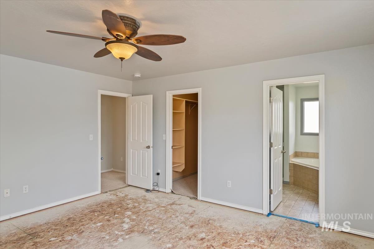 80 Cobblestone Court Middleton, ID 83644 - Photo 25 of 48 Spacious room featuring light gray walls, a ceiling fan with light fixture, and white trim