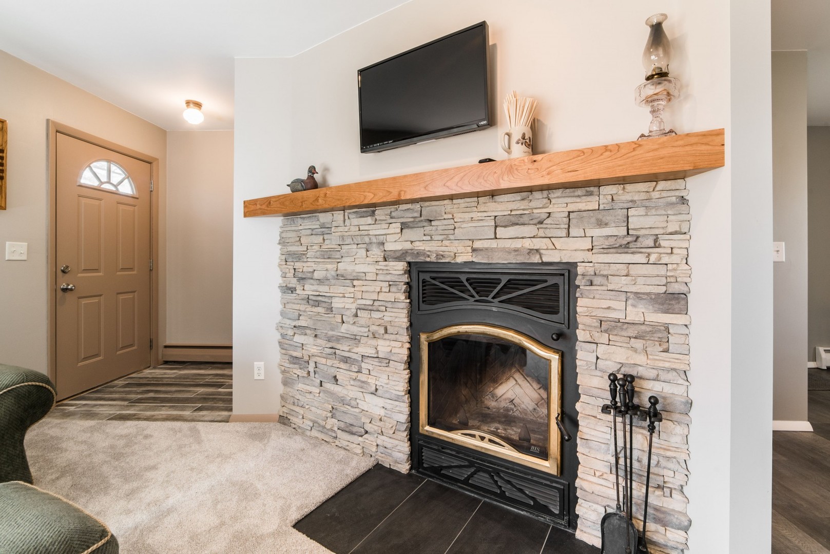 13369 Ash Road Genoa, IL 60135 - Photo 2 of 26 a living room with a fireplace and a flat screen tv
