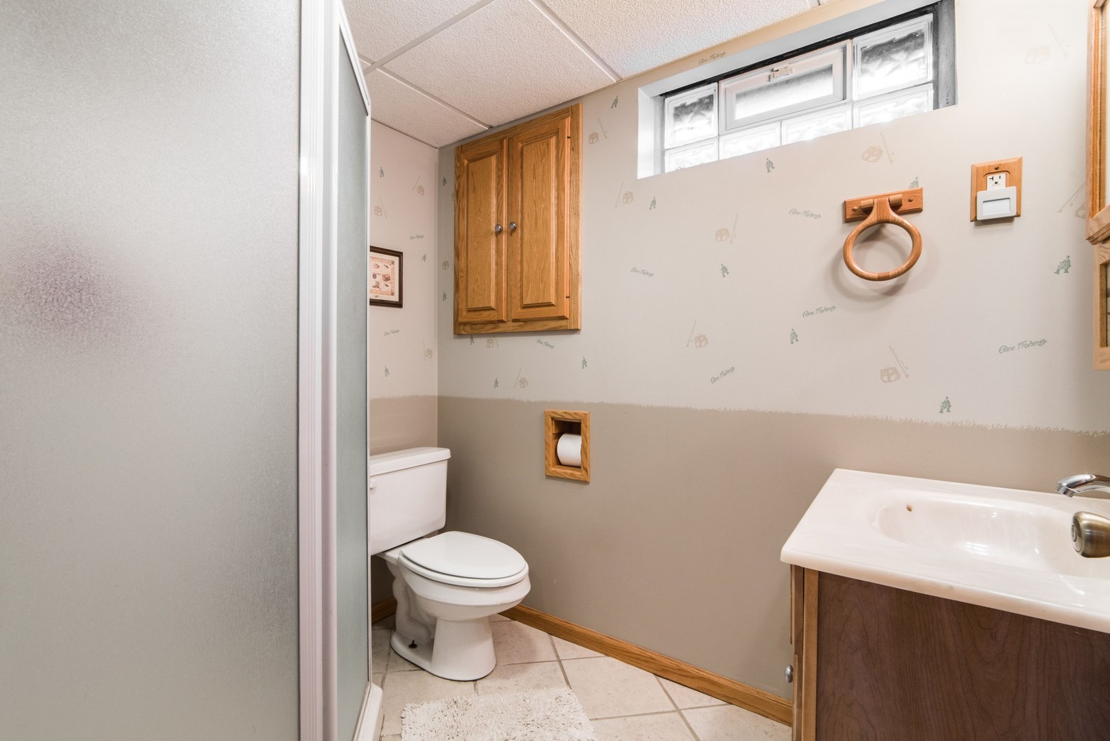 13369 Ash Road Genoa, IL 60135 - Photo 16 of 26 a white toilet sitting next to a bathroom sink