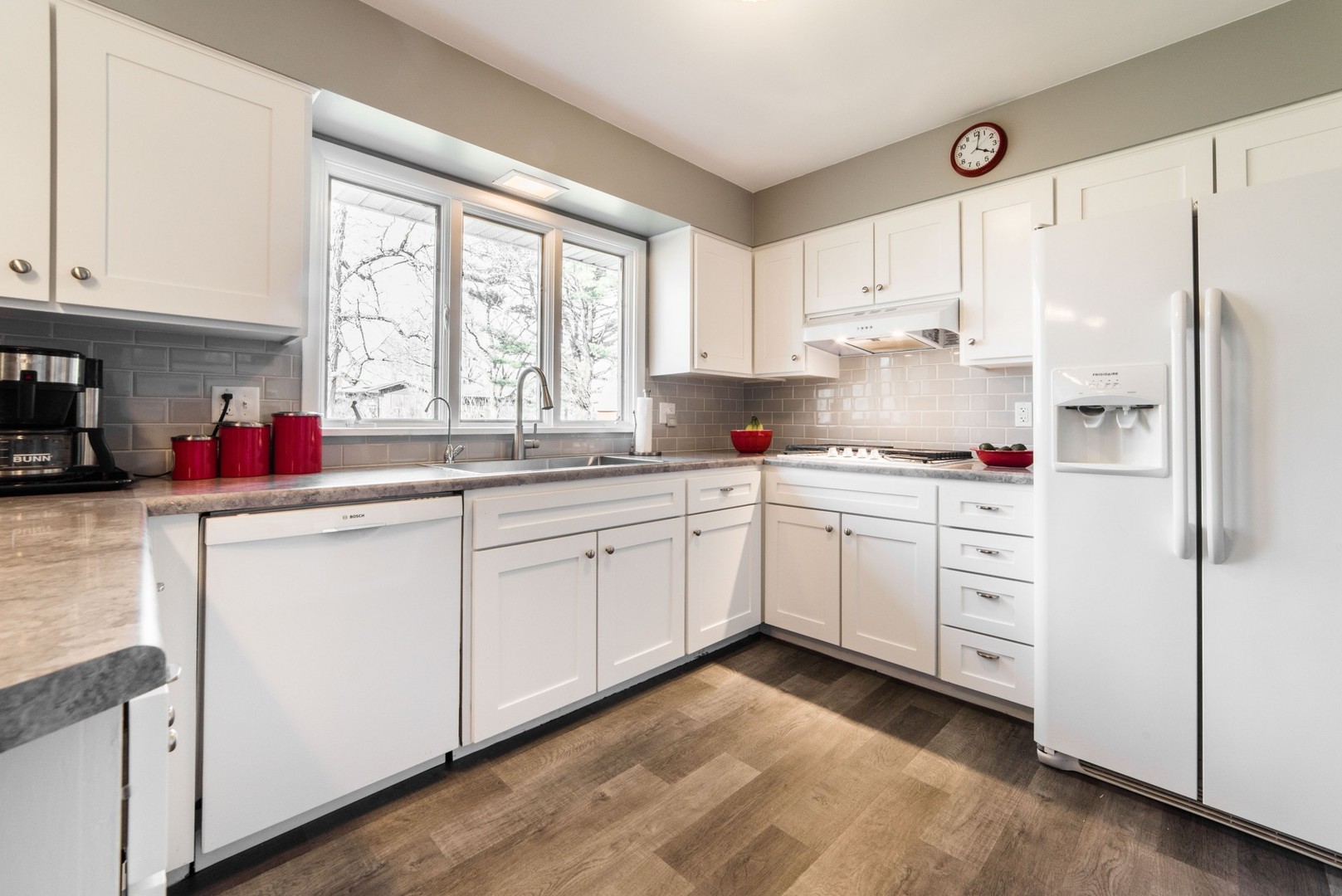 13369 Ash Road Genoa, IL 60135 - Photo 6 of 26 a kitchen with white cabinets sink and white appliances