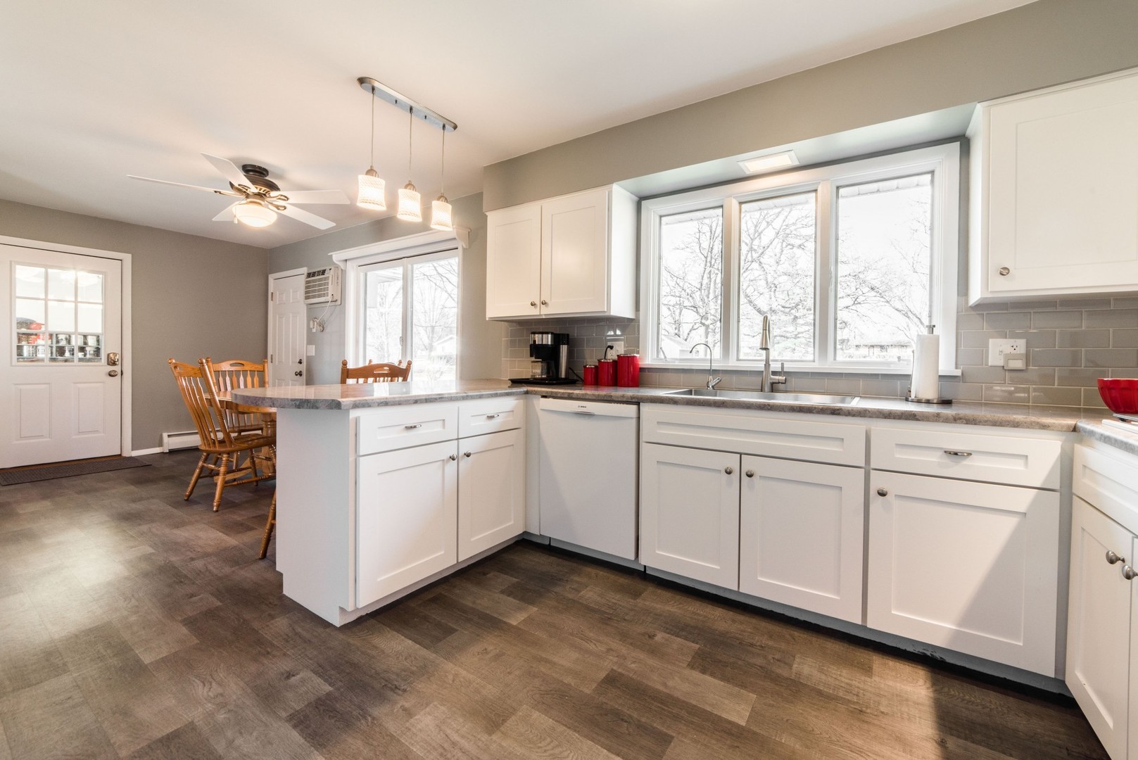13369 Ash Road Genoa, IL 60135 - Photo 7 of 26 a kitchen with a sink window and cabinets