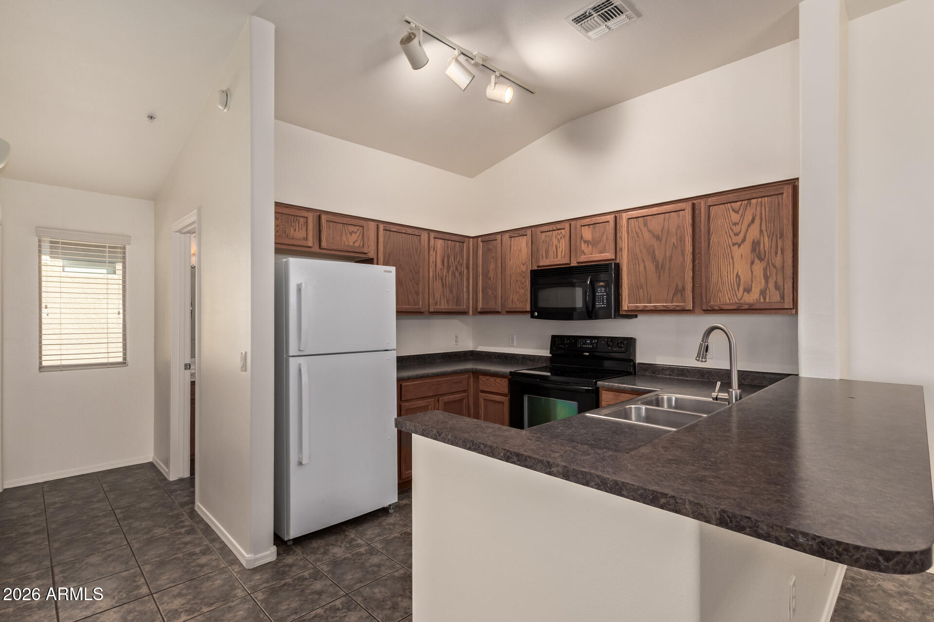 280 South Evergreen Road, Unit 1246 Tempe, AZ 85288 - Photo 12 of 25 a kitchen with stainless steel appliances granite countertop a refrigerator a stove top oven a sink and dishwasher
