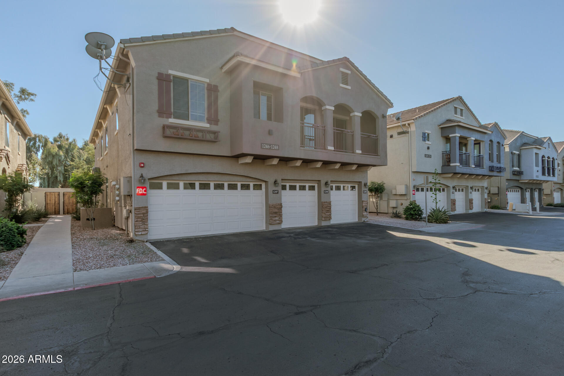 280 South Evergreen Road, Unit 1246 Tempe, AZ 85288 - Photo 2 of 25 a white house with a tree in front of it
