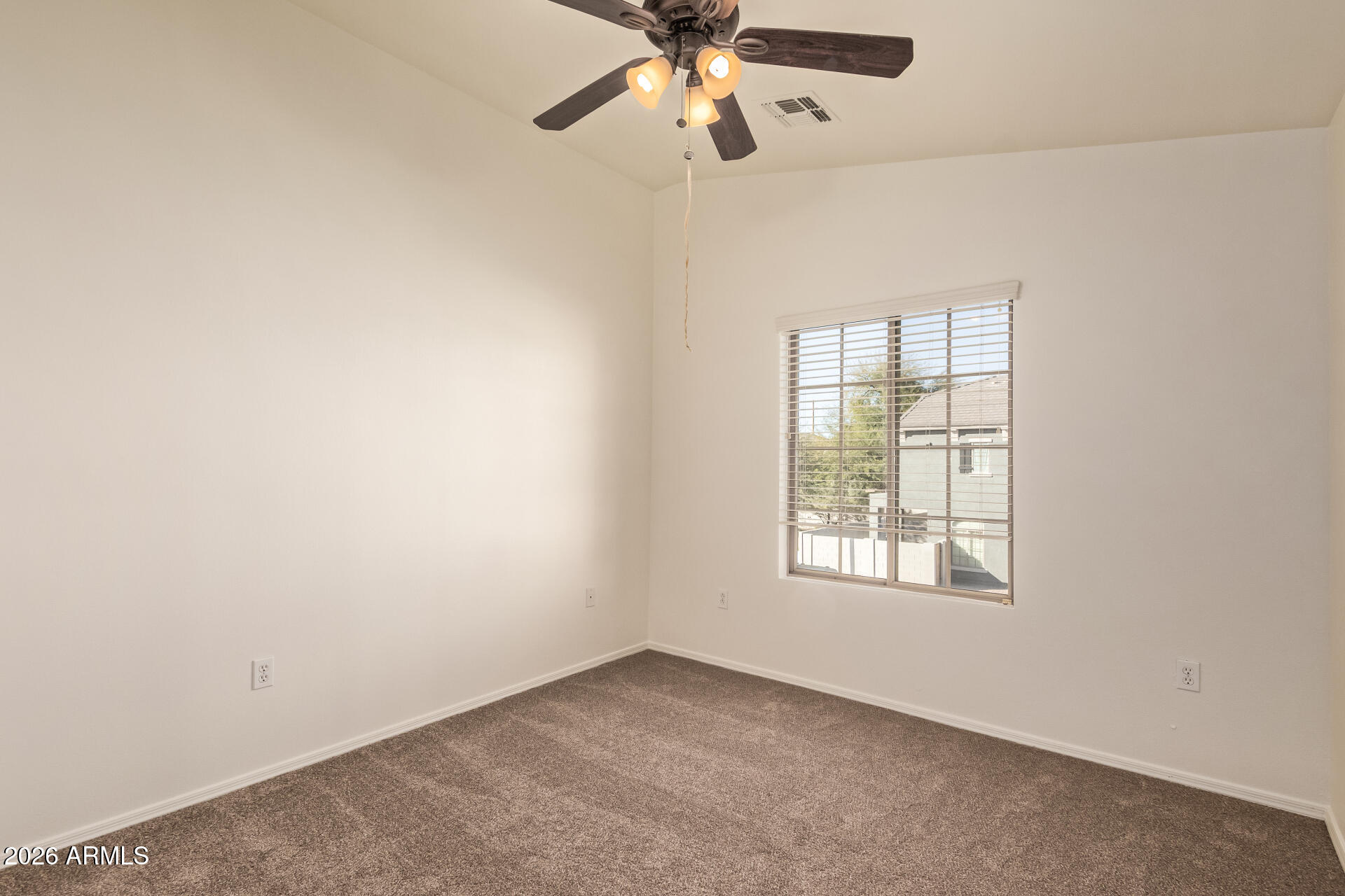 280 South Evergreen Road, Unit 1246 Tempe, AZ 85288 - Photo 23 of 25 an empty room with a window and a fan