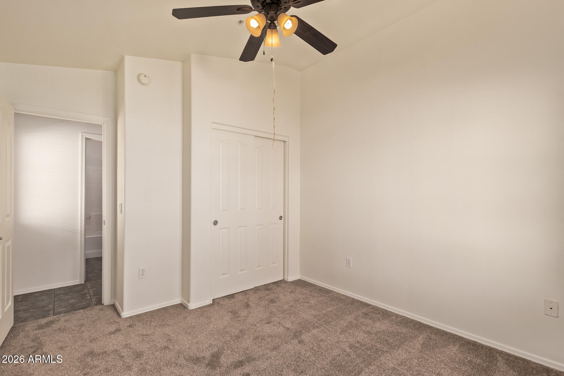 280 South Evergreen Road, Unit 1246 Tempe, AZ 85288 - Photo 24 of 25 an empty room with a ceiling fan and a window