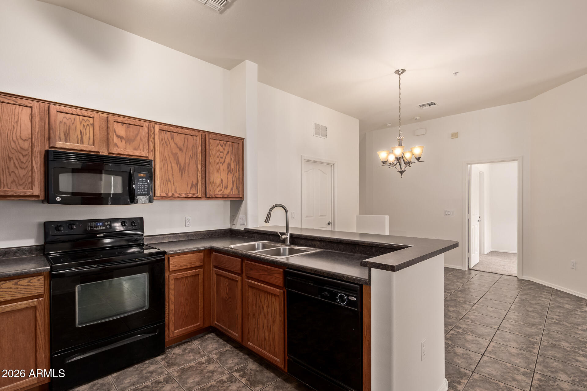280 South Evergreen Road, Unit 1246 Tempe, AZ 85288 - Photo 10 of 25 a kitchen that has a sink a stove oven a counter space and cabinets