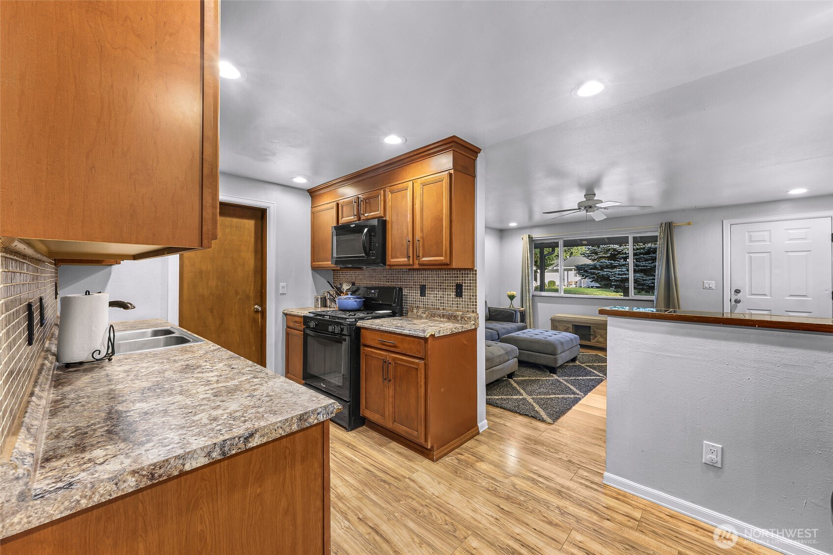 205 Cashmere Lane Everson, WA 98247 - Photo 17 of 40 a kitchen with a sink stove and wooden cabinets