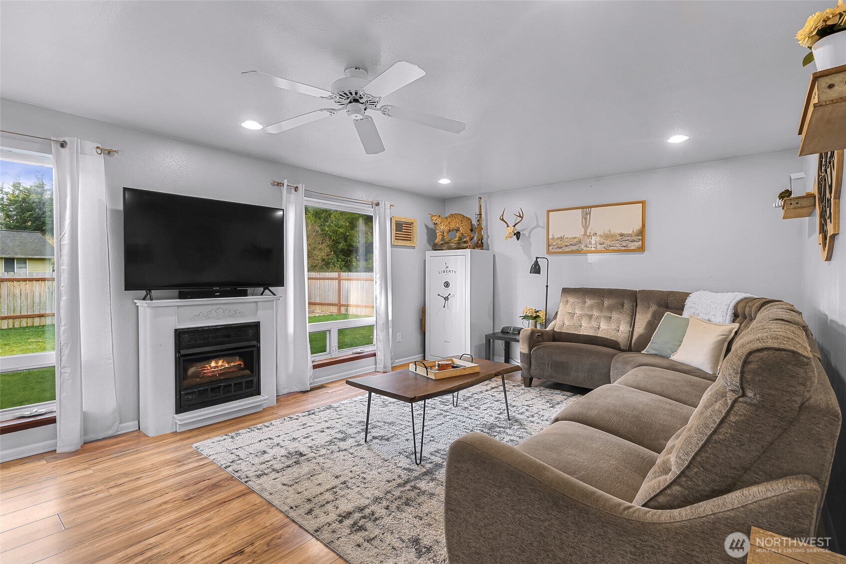205 Cashmere Lane Everson, WA 98247 - Photo 30 of 40 a living room with furniture a fireplace and a flat screen tv