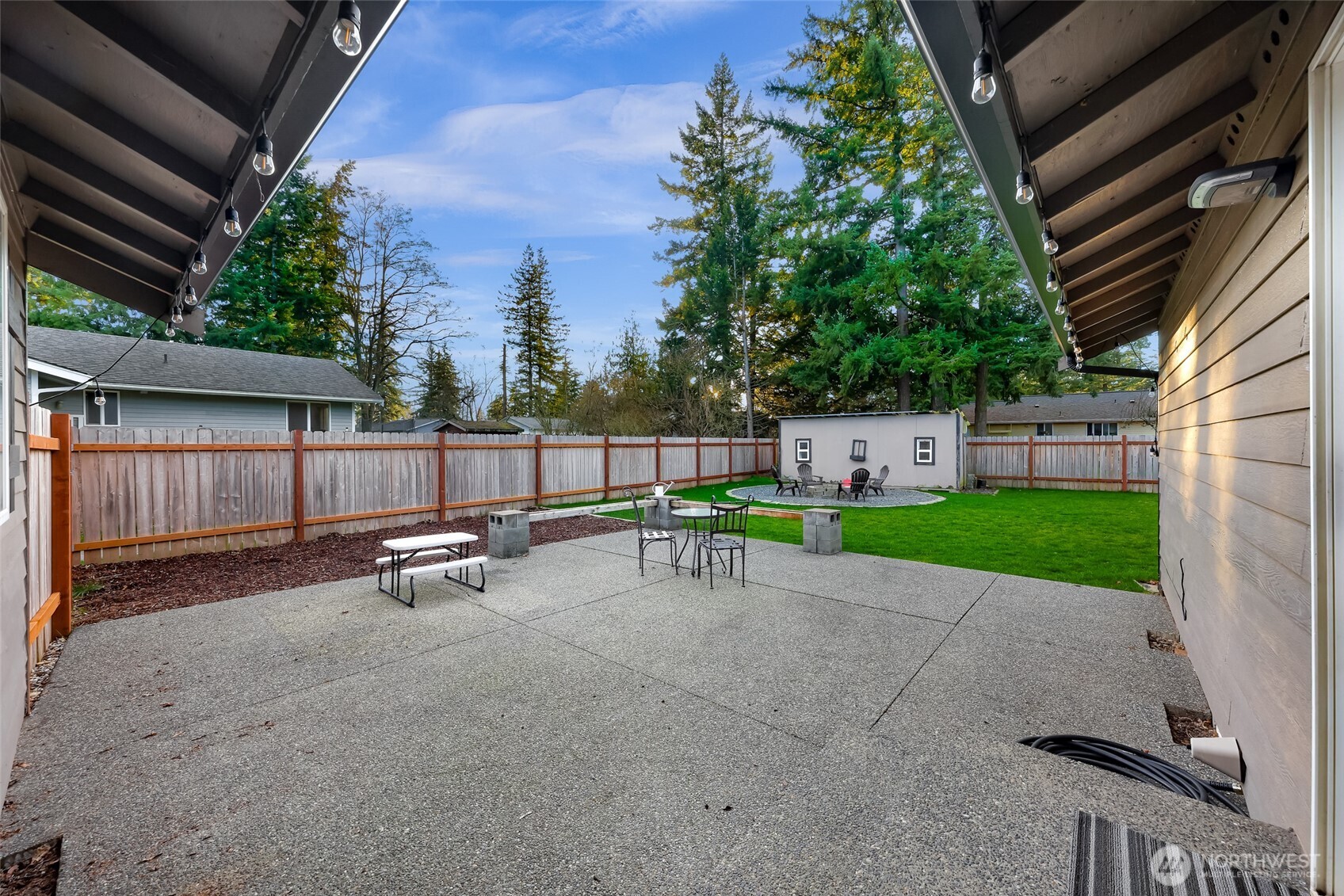 205 Cashmere Lane Everson, WA 98247 - Photo 34 of 40 a view of backyard with a table and chairs and a barbeque