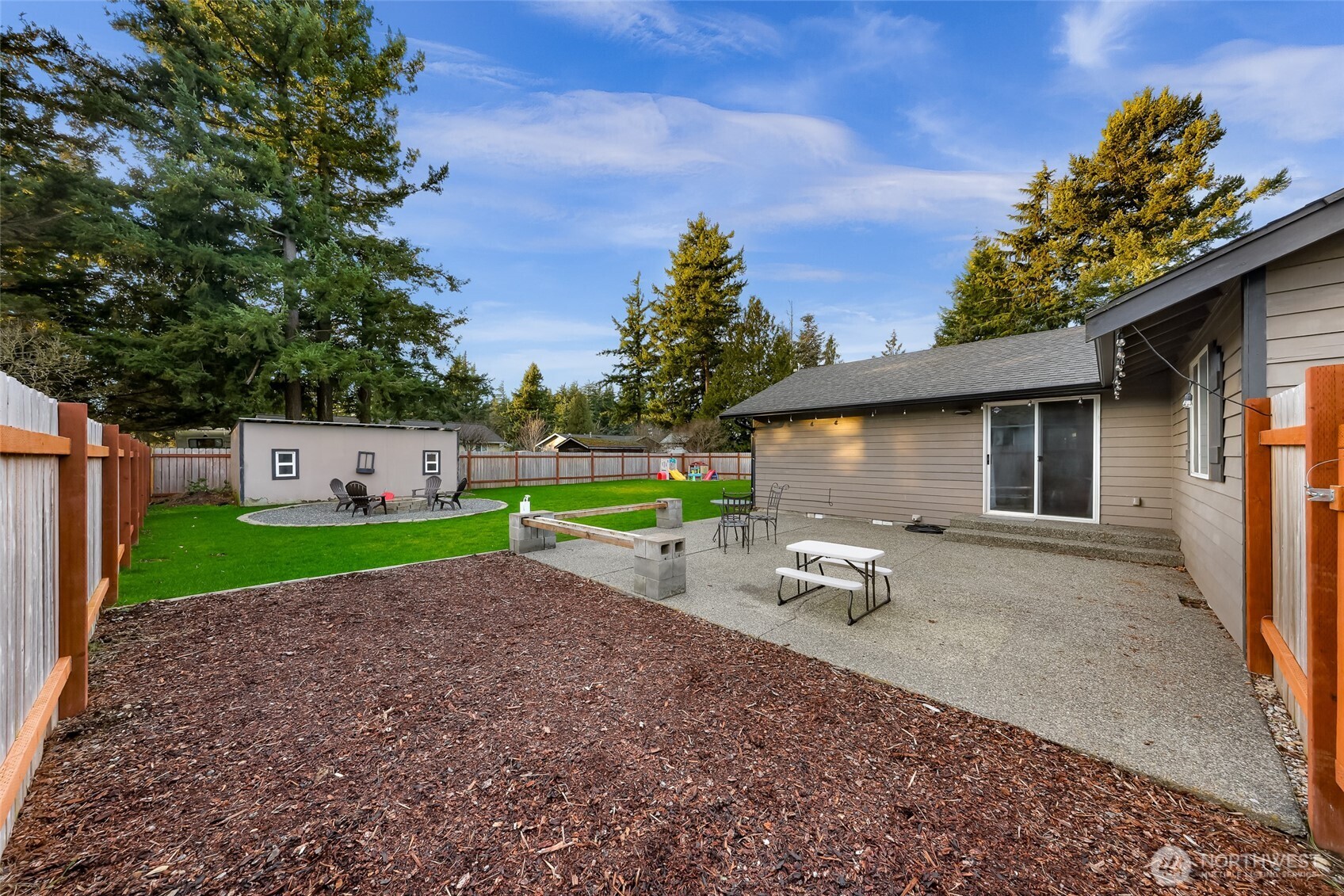 205 Cashmere Lane Everson, WA 98247 - Photo 35 of 40 a view of a backyard with couches plants and large trees