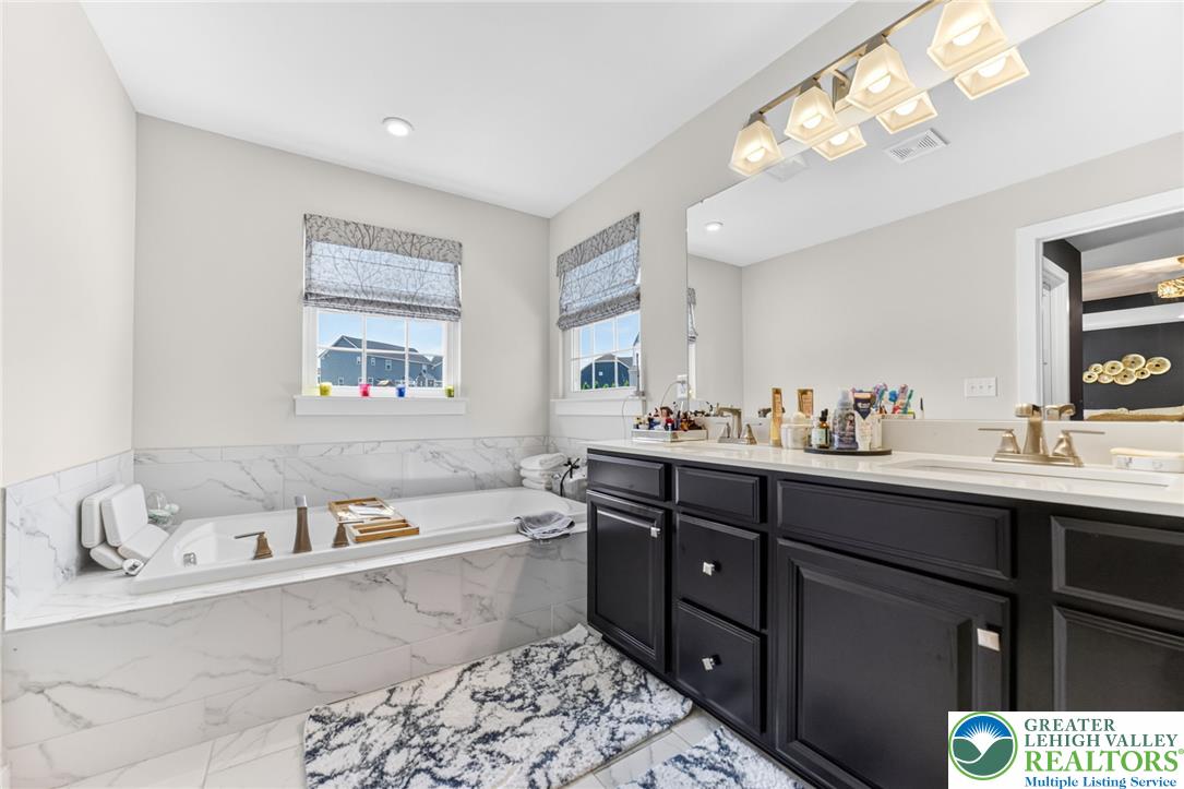 3952 Orth Street Bethlehem, PA 18020 - Photo 24 of 60 Luxurious soaking tub and a spacious double vanity create a primary bath oasis.