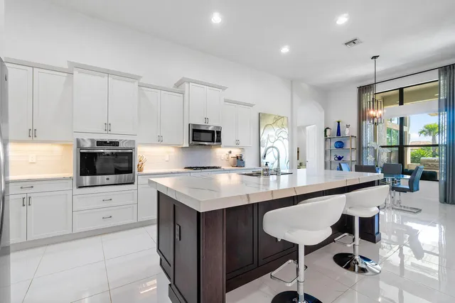 a kitchen with appliances a sink and cabinets