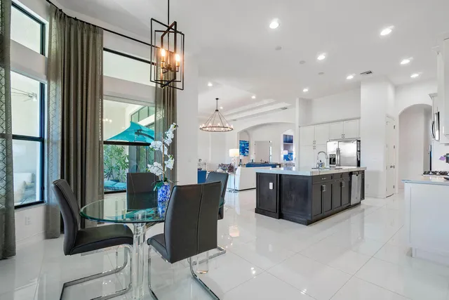 a living room with furniture a flat screen tv and kitchen view