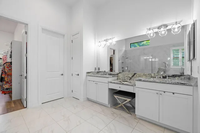 a kitchen with granite countertop a sink cabinets and stainless steel appliances