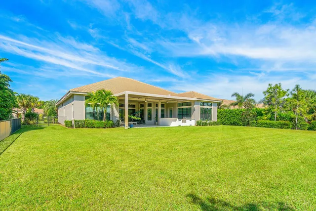 a view of an house with backyard space and balcony