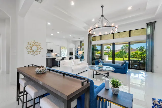 a dining room with furniture a chandelier and window