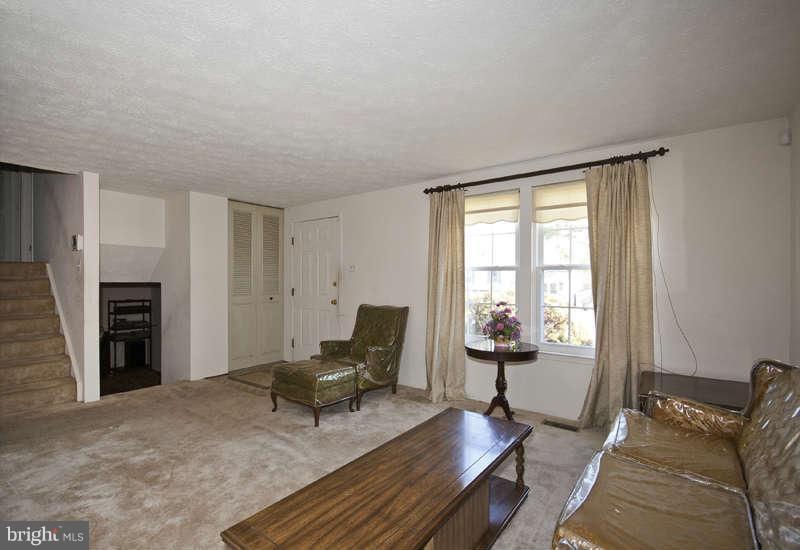 4715 Hawksbury Road Baltimore, MD 21208 - Photo 2 of 15 a living room with furniture and a fireplace