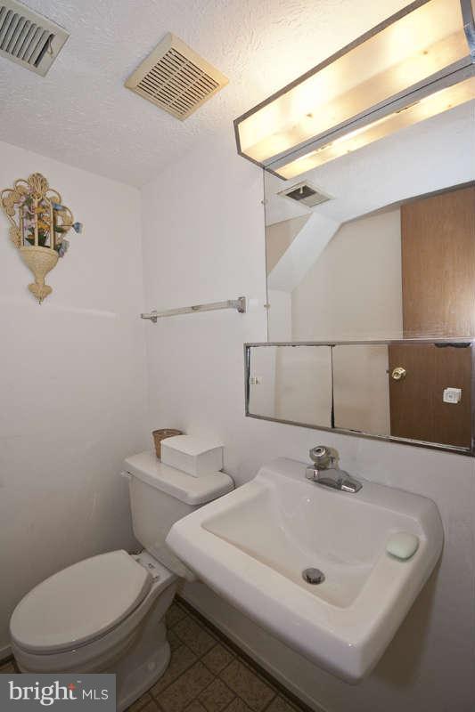 4715 Hawksbury Road Baltimore, MD 21208 - Photo 13 of 15 a bathroom with a sink and a mirror