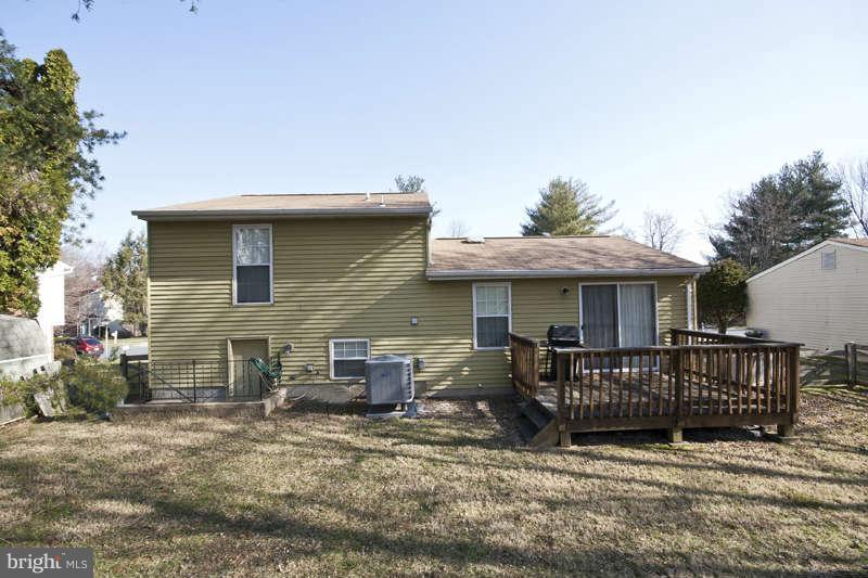4715 Hawksbury Road Baltimore, MD 21208 - Photo 15 of 15 a view of a house with a wooden deck and furniture