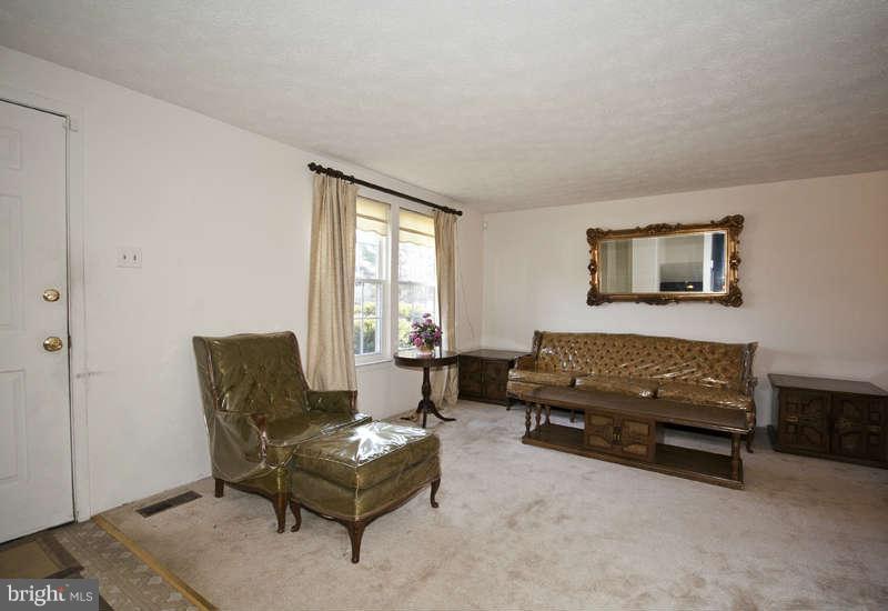4715 Hawksbury Road Baltimore, MD 21208 - Photo 3 of 15 a living room with furniture and a window