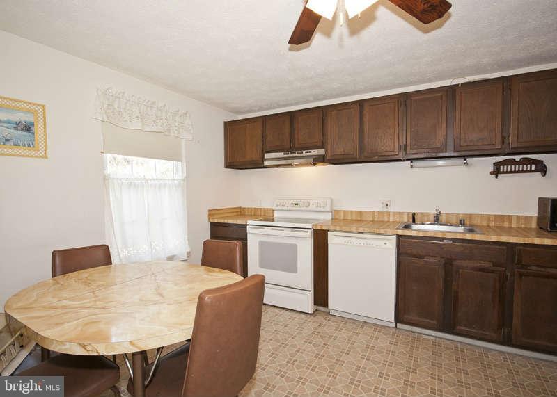 4715 Hawksbury Road Baltimore, MD 21208 - Photo 5 of 15 a kitchen with a sink cabinets and window