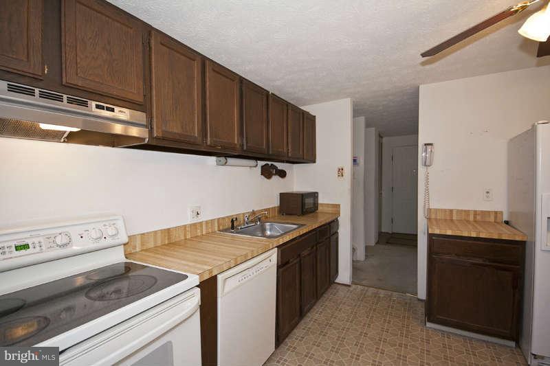 4715 Hawksbury Road Baltimore, MD 21208 - Photo 6 of 15 a kitchen with granite countertop a stove and a sink