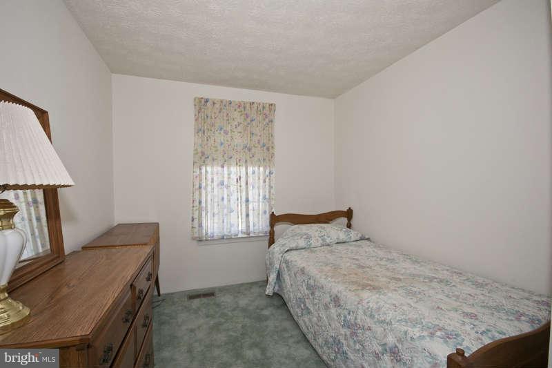 4715 Hawksbury Road Baltimore, MD 21208 - Photo 7 of 15 a bedroom with a bed and a window