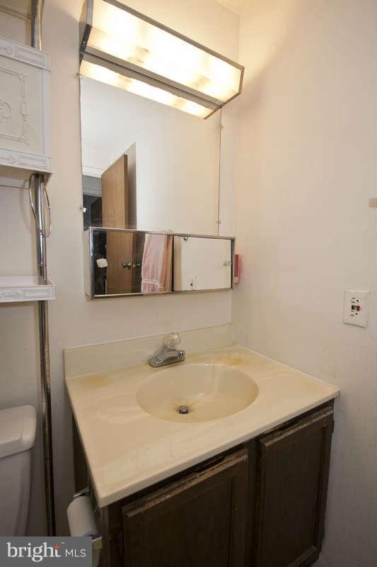 4715 Hawksbury Road Baltimore, MD 21208 - Photo 8 of 15 a bathroom with a sink and a mirror