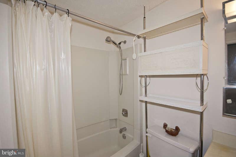 4715 Hawksbury Road Baltimore, MD 21208 - Photo 9 of 15 a bathroom with a shower and a tub