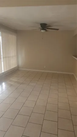 en empty room with white walls and tiles