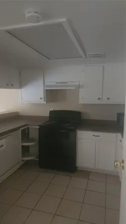 a kitchen with a cabinets and white stove