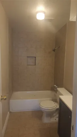 a bathroom with a toilet and shower