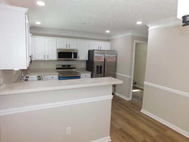 1834 Stephens Pond View Loganville, GA 30052 - Photo 8 of 25 a kitchen with stainless steel appliances a refrigerator sink and microwave