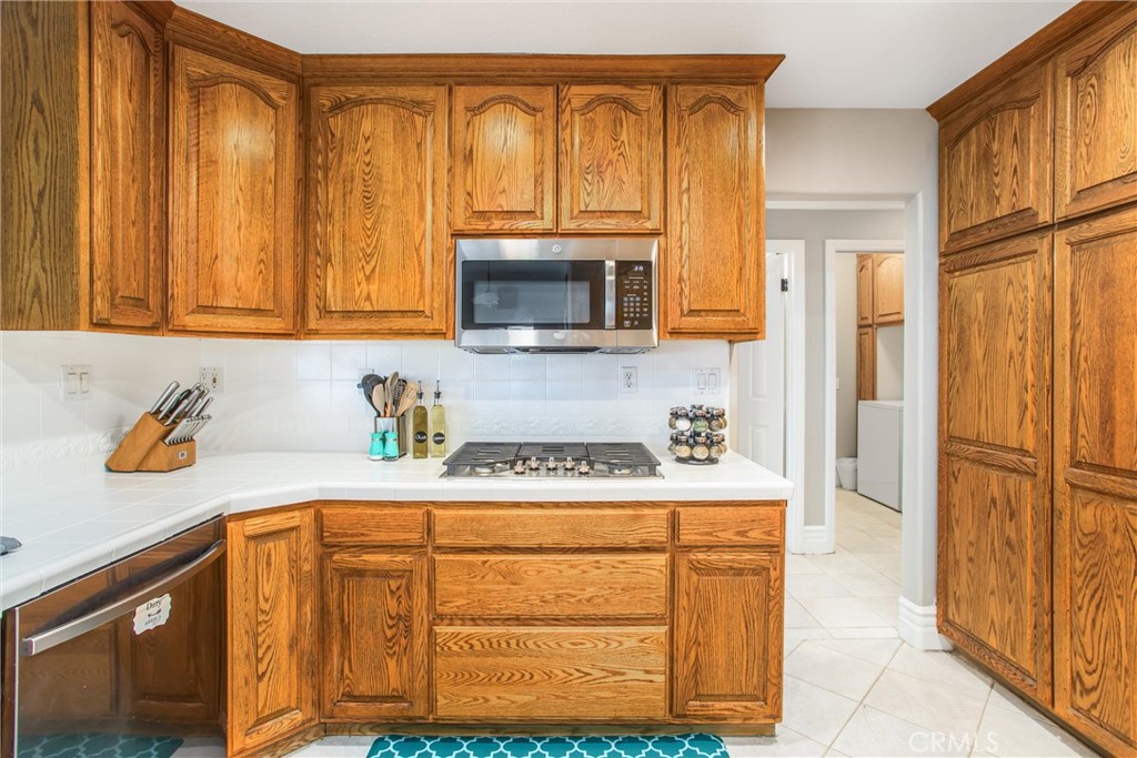 31607 Florida Street Redlands, CA 92373 - Photo 16 of 65 a kitchen with stainless steel appliances granite countertop a refrigerator and a stove top oven