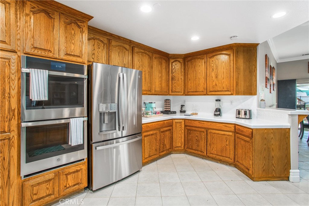 31607 Florida Street Redlands, CA 92373 - Photo 17 of 65 a kitchen with stainless steel appliances granite countertop a refrigerator and a stove top oven