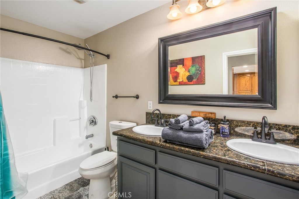 31607 Florida Street Redlands, CA 92373 - Photo 19 of 65 a bathroom with a granite countertop sink mirror toilet and bathtub
