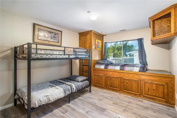 a bedroom with a bed and a ceiling fan