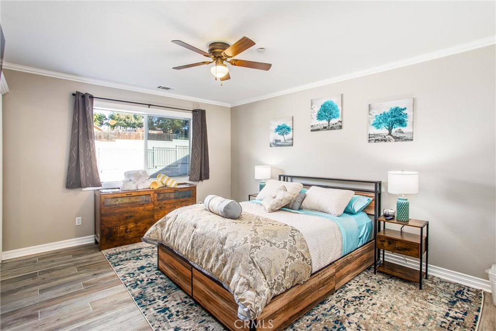 31607 Florida Street Redlands, CA 92373 - Photo 22 of 65 a bedroom with a bed and a chandelier